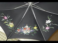 an umbrella with flowers painted on it