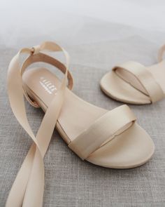 Classy satin flat sandals with ballerina lace up. Effortless yet adorable to wear on your favorite occasion. Can be pair with dress or casual look.DETAILS:COLORS AVAILABLE: Ivory, White, Pink, Light Blue, and ChampagneUPPER: Synthetic upper and liningMATERIALS: Mandmade outsoleSTYLE NAME: MADDY Summer Wedding Satin Shoes, Low Heel Satin Wedding Shoes For Summer, Summer Wedding Shoes In Satin With Closed Toe, Summer Wedding Shoes Satin Closed Toe, Summer Satin Wedding Shoes With Closed Toe, Chic Adjustable Wedding Sandals, Summer Wedding Sandals With Satin Bow, Bridesmaid Satin Wedding Shoes, Summer Flat Heel Bridesmaid Wedding Shoes