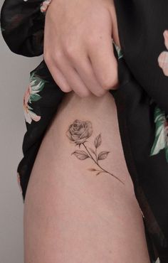 a woman with a rose tattoo on her stomach