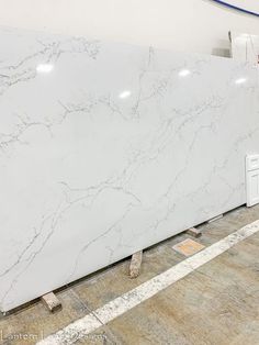 a large white marble slab is being worked on