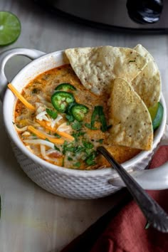 a bowl of soup with tortilla chips on the side