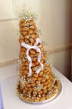 a tall tower of cookies is decorated with baby's breath