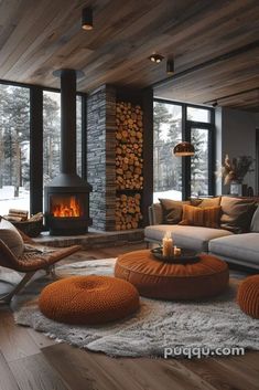 a living room filled with furniture and a fire place in the middle of it on top of a hard wood floor