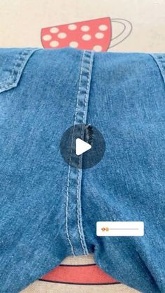 the back of a pair of jeans with an app on it's side and a video playing button