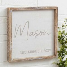 a wooden framed sign with the word mason written in cursive writing on it