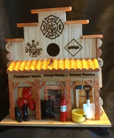 a toy fire station made out of wood