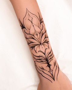 a woman's foot with a tattoo design on it