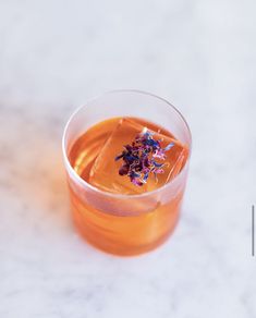 a glass filled with liquid sitting on top of a table