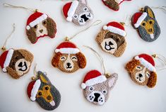 christmas ornaments made to look like dogs wearing santa hats