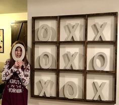 a woman holding up a magnifying glass in front of an xoxo sign