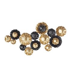 gold and black flowers are arranged on a white surface, with one flower in the center