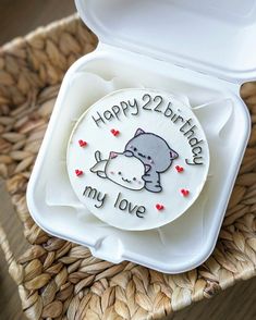 a birthday cake in a white box on a wicker tray with the words happy 2nd birthday my love