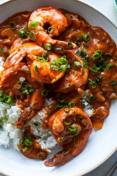 a bowl filled with shrimp and rice on top of a table