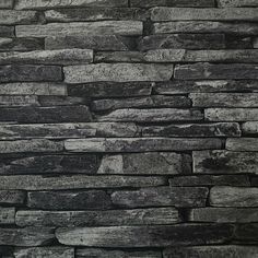 a black and white photo of a stone wall