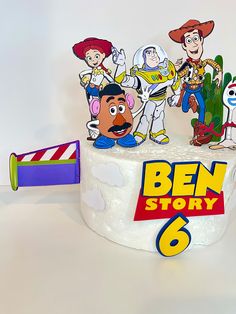 a birthday cake with toy story characters on it and a sign that says ben story 6