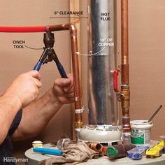 a man fixing a water heater in his home's basement with plumbing tools