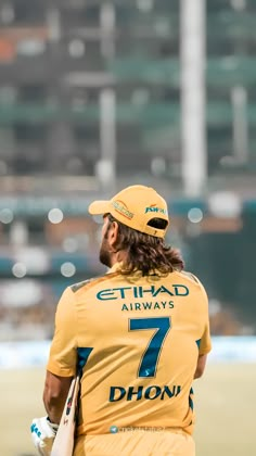 a man with long hair wearing a yellow uniform