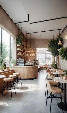 the interior of a restaurant with tables, chairs and plants on the wall behind the counter