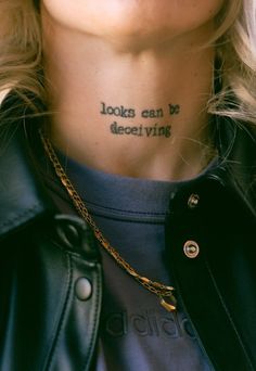 a woman with a tattoo on her neck that says looks can be deceiving