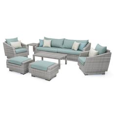 an outdoor furniture set with blue cushions and pillows on the couch, coffee table and ottoman