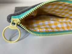 PRIA cosmtiec purse, lined in a gorgeous yellow or red gingham.  The PRIA has an awesome chunky zip  〰️ with a large zip pull. Perfect size to slot your essentials into  so they don't get lost in the ether of your bag! Your purchase will come gift wrapped in pretty tissue paper so perfect as a readymade gift for someone special 💝 Yellow Pouch Coin Purse For Travel, Yellow Zipper Pouch Cosmetic Bag For Everyday Use, Yellow Zipper Pouch For Personal Use, Yellow Pencil Case With Zipper Closure For Daily Use, Yellow Pencil Case With Zipper For Daily Use, Yellow Zipper Pouch Coin Purse For Daily Use, Yellow Coin Purse With Zipper For Everyday Use, Red Gingham, Cosmetic Bags