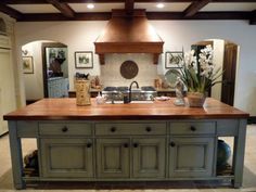 a large kitchen island in the middle of a room with an oven and counter top