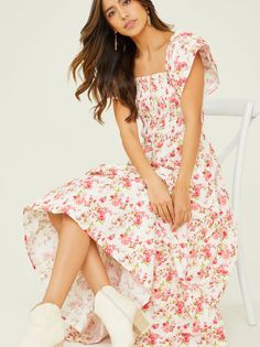 Elevate your wardrobe with the timeless elegance of this floral maxi dress. The smocked detailing ensures a comfortable and secure fit, while the square neckline adorned with ruffle lining adds a touch of romantic charm. Complete with graceful ruffle sleeves and a tiered design, this dress is perfect for making a statement at any special occasion. White And Pink Floral Dress, Feminine Flowy Tiered Floral Dress, Flowy Square Neck Floral Dress With Ruffles, Feminine Floral Dress With Square Neck And Ruffles, Feminine Flowy Floral Print Tiered Dress, Flowy Tiered Floral Dress With Smocked Back, Cute Floral Dresses, Cute Maxi Dress, Pink And White Dress