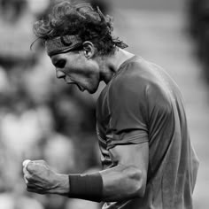 black and white photograph of a tennis player holding his racquet in one hand