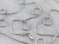 This snake chain has subtle faceting that makes it sparkle in the light! Sleek and versatile, this necklace could be worn with a pendant, or layered for a modern look. Metal: 14K White Gold Width of Chain: 1.1 mm Length of Chain: 20 Inches Marks: “14k Italy” Stamped on clasp Chain Layering, Claw Necklace, White Gold Chain, White Gold Necklace, White Gold Chains, Layered Chains, White Gold Necklaces, Chain Pendant, Snake Chain