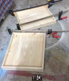 two pieces of wood are being assembled on the floor