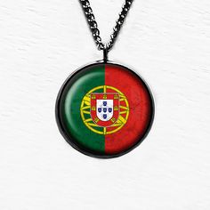 Portugal Portuguese Flag Pendant & Necklace. Just as we are all unique, each piece is handcrafted and slightly differs from the last and next. Only you belong to this piece. These pieces are resistant, but not waterproof. Please remove before swimming or bathing. If you care for it as gently as we have it will last as a reminder of a place in time, an adventure, or something that moved you. We'd happily work with you to design something you'd like to see in a pendant-  bulk orders welcomed-as we Peruvian Flag, We Are All Unique, Portuguese Flag, Welsh Flag, Brown Leather Necklace, Leather Necklace, Beautiful Things, Antique Bronze, In Time