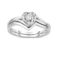 a heart shaped diamond ring set on top of a white gold wedding band with two diamonds in the middle