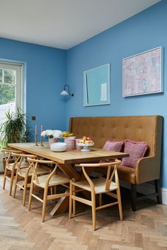 a dining room with blue walls and wood flooring