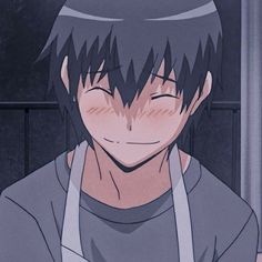 a man with black hair and an apron on