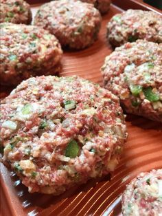 several hamburger patties on a tray ready to be eaten