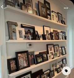 the shelves are filled with pictures and family photos