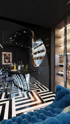 a room with black and white flooring, blue couches and bar stools