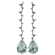 Emulating femininity and glamour, the Whispering collection is full of colour and form. Inspired by the twisting, sculptural shape of the exotic Orchid flower. Whispering long earrings cascading with delicate twirls of brilliant diamonds and green garnets suspending pear-cut green amethysts, each weighing 15ct. Finished in black rhodium plate on 18ct white gold. - Size (HxW): 79mm x 15mm - Weight per earring: 7.5gm - Earring fitting: post Fei Liu Fine Jewellery is an independent jewellery designer brand based in the historic Birmingham Jewellery Quarter, England. Kindly be informed that when acquiring goods from Fei Liu Fine Jewellery, there is a possibility of incurring customs fees or import duties, contingent on the regulations of the destination country. It is essential to bear in mind Luxury Green Pear-shaped Earrings, Luxury Pear-shaped Green Earrings, Luxury Green Pear Shaped Earrings, Luxury Tourmaline Drop Earrings, Diamond Orchid Earrings, Long Drop Earrings 1stdibs, Birmingham Jewellery Quarter, Green Garnet, Black Rhodium