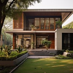 a modern house in the middle of a lush green yard with stairs leading up to it