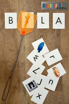 the word bla is spelled out with cut outs and scissors on top of it