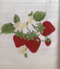 a close up of a piece of cloth with strawberries on it