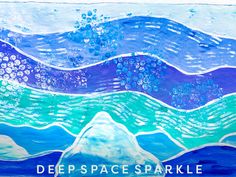 an art project with blue and green watercolors on paper that says deep space sparkle