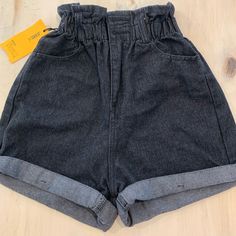 Brand New Denim Shorts In Great Black Rinse. The Silhouette Is Up To Date With Cinched Waist And Wide Legs That Hit Just Above The Knees. Great Pewter Button Details. Hard To Find. Black High Rise Bottoms With Elastic Waistband, High Waist Black Denim Bottoms, High Waist Black Jeans With Elastic Waistband, Black Denim Bottoms With Built-in Shorts, Fitted Washed Black Shorts, Fitted Washed Black Short Bottoms, Trendy Washed Black Bottoms With Built-in Shorts, High-waisted Black Denim Shorts, Black High Waist Denim Shorts