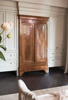 a large wooden cabinet sitting in the middle of a room