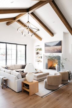 a living room filled with furniture and a fire place in the middle of a room