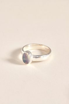 Our Ethiopian Opal ring is perfect for everyday wear. The ring is made using 925 sterling silver. The ring is available in size 7 3/4, 8.5, 8 3/4, 10. Dimensions: Total height: 9mm Total width: 7mm Stone height: 8mm Stone width: 6mm Stone + bezel thickness: 5mm Band width: 4mm - Please note - * Additional photos and videos available on request * Go to 'About us' section for links to our socials and website * Only the ring from first picture is included in the price. * Gemstones are natural material, they can slightly differ in color, size, shape and may show some inclusions or cracks inside the stone itself. We do take great care in picking the best quality stones for best quality jewellery. Sterling Silver Solitaire Signet Ring For Promise, Classic Everyday Sterling Silver Birthstone Ring, Sterling Silver Opal Promise Ring, Sterling Silver Opal Ring With Polished Finish, Sterling Silver Cabochon Rings For Formal Occasions, Hallmarked Sterling Silver Oval Rings, Formal Sterling Silver Cabochon Rings, Formal Cabochon Ring In Sterling Silver, Oval Sterling Silver Stackable Rings With Polished Finish