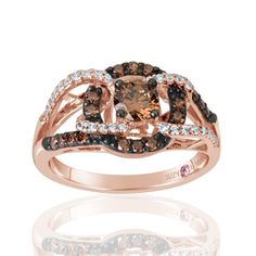 Eye-candy so delicious you'll never want to take it off. This tasteful style is rich in color, fashion and design. A tasteful brown round-cut cubic zirconia is centered in a halo of brown cubic zirconia amidst a gladiator crossover of white sparkling gemstones. Bringing together a center stone classic style partnered with a modern crossover design to create a magestic drapery of gemstones with a unique twist. This ring is designed by Suzy Levian with a message. By creating jewelry that is beauti Gladiator Ring, Modern Eternity Band, Gemstone Brooch, Cubic Zirconia Bracelet, Chocolate Diamonds, Magnificent Century, Halo Setting, Cubic Zirconia Jewelry, Backdrop Design