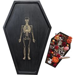 a wooden box with a skeleton on it next to an assortment of halloween candies