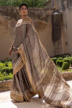 Grey saree with garden hand block print and hand weaved zari border. Comes with an unstitched blouse piece.
Components: 2
Pattern: Hand Block Printed
Type Of Work: Garden
Fabric: Pure Tussar Silk
Color: Grey
Other Details: 
Length of saree: 5.5 mtrs
Approx. product weight (in gms): 210
Note: Stitched blouse worn by the model is not for sale
Disclaimer: Since these products are handcrafted and hand dyed, hence may have slight irregularities and dissimilarities each time it is crafted. This is a n Bohemian Handloom Pre-draped Saree For Wedding, Bohemian Blouse With Zari Weaving, Bohemian Blouse Piece With Zari Weaving, Bohemian Style Pre-draped Raw Silk Saree, Bohemian Pre-draped Saree With Zari Weaving, Bohemian Designer Raw Silk Saree, Bohemian Designer Handloom Saree, Bohemian Pre-draped Saree With Zari Weaving For Traditional Ceremonies, Bohemian Silk Blouse Piece With Zari Weaving