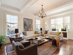 a living room filled with furniture and a chandelier